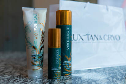 VersaSpa skincare and tanning products on marble surface.